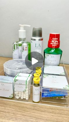 a wooden table topped with lots of bottles and containers filled with personal care items on top of it