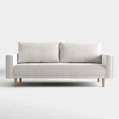 a white couch sitting on top of a wooden floor