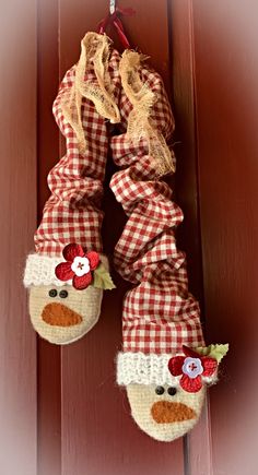 a close up of a pair of shoes hanging on a doorknob with flowers