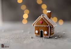 a small gingerbread house sitting on top of a table