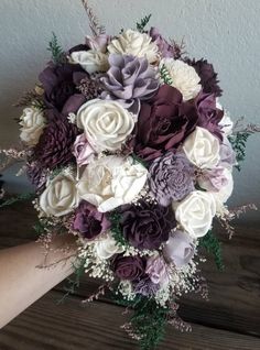 a bridal bouquet with purple and white flowers