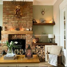 a living room filled with furniture and a fire place in front of a brick fireplace