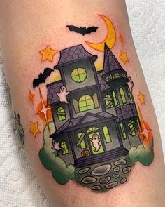 a halloween tattoo with a house on it