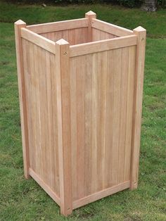 a large wooden box sitting in the grass