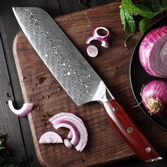 a cutting board with onions and a knife on it next to other vegetables, including radishes