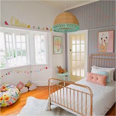 a child's bedroom decorated in pastel colors