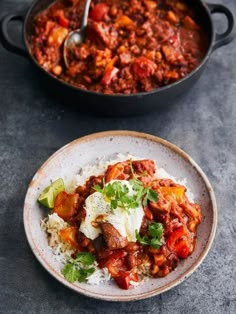 two bowls of chili and rice on a table