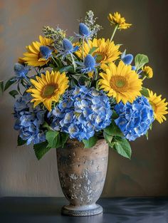 a vase filled with blue and yellow flowers