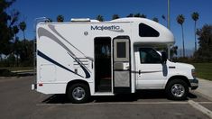 a white motor home parked in a parking lot