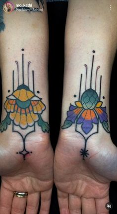 two people with matching tattoos on their hands