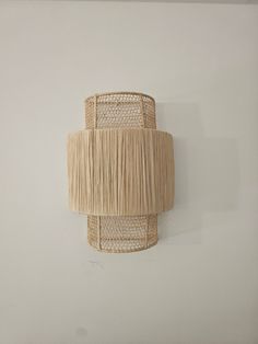 This wall sconce embodies the very essence of Moroccan craftsmanship, combining both aesthetic beauty and practical functionality. Handcrafted, it features a metal frame, offering a sturdy and elegant structure. Raffia, a natural fiber derived from palm leaves, is the central element of this creation. Carefully woven, it adds a touch of authenticity and charm to the overall piece. The filtered light through the raffia creates a warm and soothing ambiance, casting a delicate glow on the surroundi Honeycomb Wall Decor, Rattan Wall Light, Rattan Wall Lights, Raffia Lamp Shade, Wall Rattan Lamp, Bamboo Wall Lamp, Raffia Pendant Light, Honeycomb Wall, Wall Scone