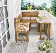 a wooden bench sitting on top of a tiled floor next to a table and chairs