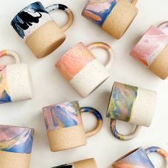 coffee mugs with different designs on them sitting next to each other in the shape of rings