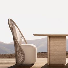 two chairs and a table on a wooden deck