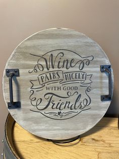 a wooden sign that says wine pairs nicely with god and friends