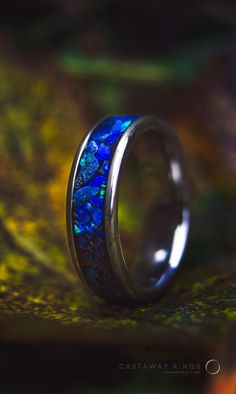 Here I have an opportunity for you to own a magnificent lapis lazuli and blue opal ring encased in an 6mm wide tungsten carbide core.  This ring is handmade by myself with only AAA grade deep blue Lapis Lazuli gemstone. The gems have been crushed into a small chunks, hand picked and inlayed 1 by 1 for the best fit of the pieces. If you didn't know Lapis Lazuli has a vast history being praised by the Ancient Egyptians, Romans and Greeks for its beautiful colours and the mystical powers that's why Mens Lapis Lazuli Ring, Blue Opal Promise Ring, Blue Opal Inlay Ring For Anniversary, Blue Opal Round Ring, Blue Opal Ring With Inlay For Anniversary, Blue Round Opal Ring, Anniversary Blue Opal Ring With Inlay, Blue Opal Rings For Anniversary, Opal Inlay Ring Gift