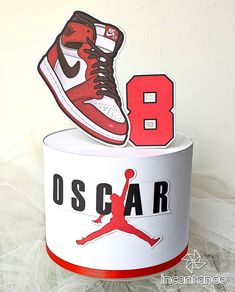 a red and white air jordan shoe on top of a box with the number 8