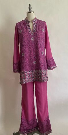 "1990's custom made fuchsia kurti set features a long tunic with a split hem at the sides, bell sleeves and split neck. Trousers are flared with a pleated high waist with elastic in the back . Top and pants are embellished with silver embroidery and sequins. Fabric is a lightweight polyester crepe and is lined with the same crepe within the bodice area. Pants are lined in a lightweight poly chiffon. Both top and bottom are in very good condition though the trousers have a small ink stain near on Bell Sleeves Kurti, Kurti Top, Sequins Fabric, Silver Embroidery, Kurti Set, Silk Chiffon Dress, Beaded Bodice, Dress Out, Ink Stain