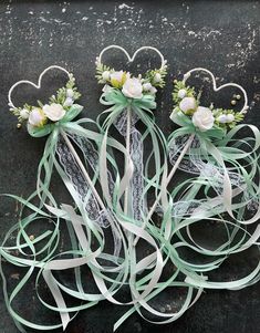 wedding flowers and ribbons are arranged in the shape of hearts