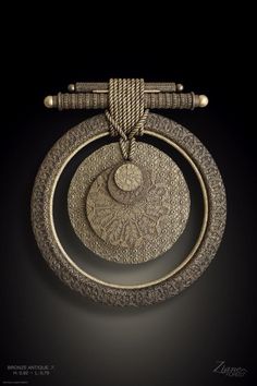 an intricately designed object is shown on a black background, with gold trimmings