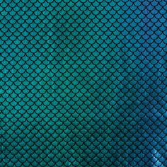 a blue and green fish scale pattern with some light reflection on the surface stock photo