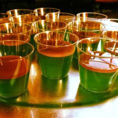 several shot glasses are lined up on a table