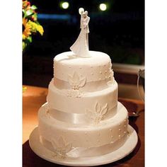 a white wedding cake sitting on top of a table