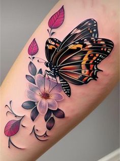 a woman's leg with a butterfly and flower tattoo on the side of her arm