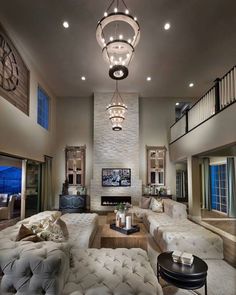 a living room filled with lots of furniture and a large clock mounted to the wall