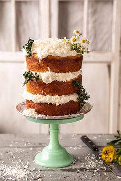 a three layer cake with flowers on top