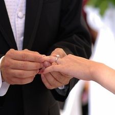 the bride and groom are exchanging their wedding rings