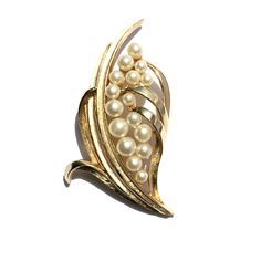 Beautiful collectable vintage brooch by Crown Trifari is made of gold gilt cast long tapered leaves with glass pearls, sixteen in all. The detailed leaves are done in brush and polished finishes. Perfect on a coat, wrap, jacket, clutch, wedding sash, reception dress or hair as bridal jewelry on your special day. Wear it again for a lifetime of special occasions. Trifari made brooches such as this one of such quality to be worthy of passing down to your own daughter one day. Makes a lovely gift f Vintage Trifari, Crown Trifari, Wedding Brooch, Wedding Sash, Wrap Jacket, Jewelry Bridal