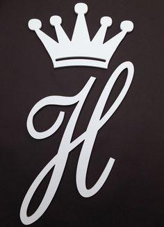 the letter h with a crown on it is shown in white and has black background