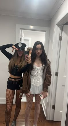 two women dressed up in costumes taking a selfie