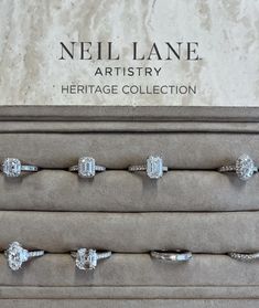 four diamond rings are sitting on display in a jewelry box with the name neil lane artistry heritage collection