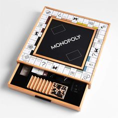 an unopened monopoly board game is shown in its wooden box with the word monopoly written on it