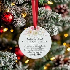 a personalized ornament hanging from a christmas tree