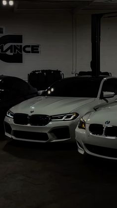 two cars parked in a garage next to each other