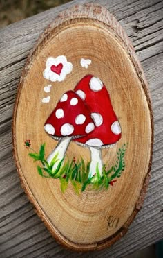 a piece of wood with a painted mushroom on it