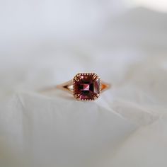 Say hello to the beautiful Square Raspberry Tourmaline Ring! This beautiful ring is an instant classic. A perfect engagement ring for the unconventional bride or even a right hand ring. If you love pinks and reds, this is the statement ring for you! Details: 14k rose gold OOAK (one of a kind) Hand engraved setting Size 6 *Can be resized**Please Write Desired Size in Note Section Upon Checkout** Raspberry Tourmaline measures about 6.3mm Free Shipping on Domestic Orders Materials: tourmaline, 14k Vintage Baguette Ring, Beautiful Gold Engagement Rings, Red And Gold Engagement Ring, Ruby Engagement Ring Vintage, Unconventional Bride, Statement Engagement Ring, Tourmaline Engagement Ring, Gemstone Wedding Rings, Right Hand Ring