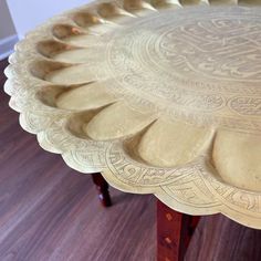 an ornately designed tray sits on a wooden table