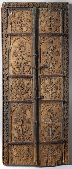 an old wooden door with carvings on the front and back panels, which have been carved into