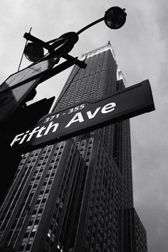 the street sign for fifth avenue is in black and white