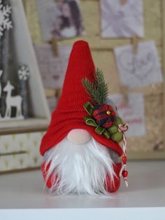 a small red and white gnome hat on top of a table