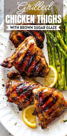 grilled chicken thighs with brown sugar glaze and asparagus on a white plate