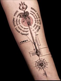 a person with a tattoo on their arm that has an arrow and some words in it