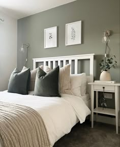 a white bed sitting in a bedroom next to a window