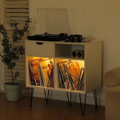 a record player is sitting on top of a cabinet