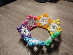 there are many beads on the table and one is multicolored with different colors