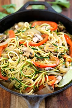 a skillet filled with noodles and vegetables